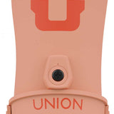 Union Women's Legacy Snowboard Binding 2024 - A light pink snowboard binding with a large "U" logo in coral on top, and the word "UNION" in coral on the front strap.