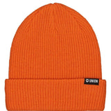 Union Low Cuff Beanie 2023 - A burnt orange beanie with a black label featuring the word "UNION" in white letters.