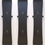 Union Snowboard Wall Mount 2023-2024 - Black metal wall mount with a minimalist design, featuring two horizontal bars and a small logo at the top.