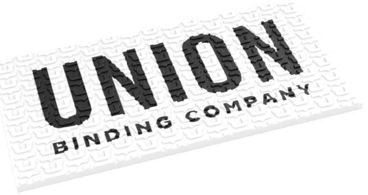 Union Surf Stomp Pad - A white surfboard pad with a repeating pattern of small, dark gray circles and lines.