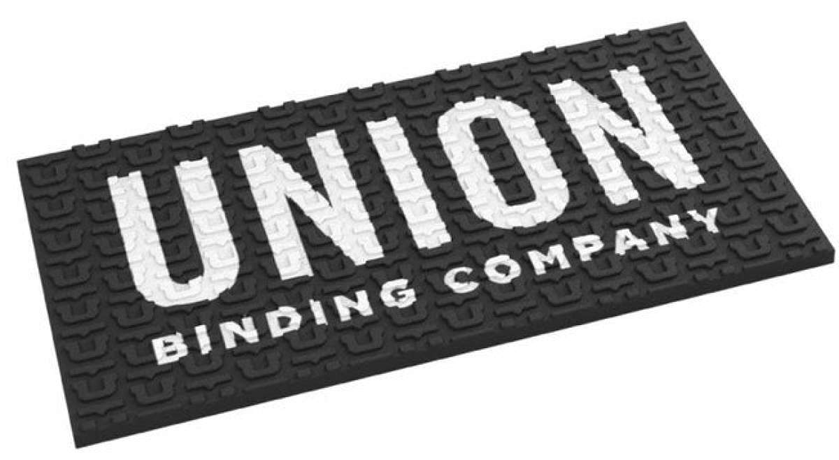 Union Surf Stomp Pad - A black surfboard pad with a white logo that reads "UNION" in large letters and "SURF STOMP PAD 2024" in smaller letters underneath.