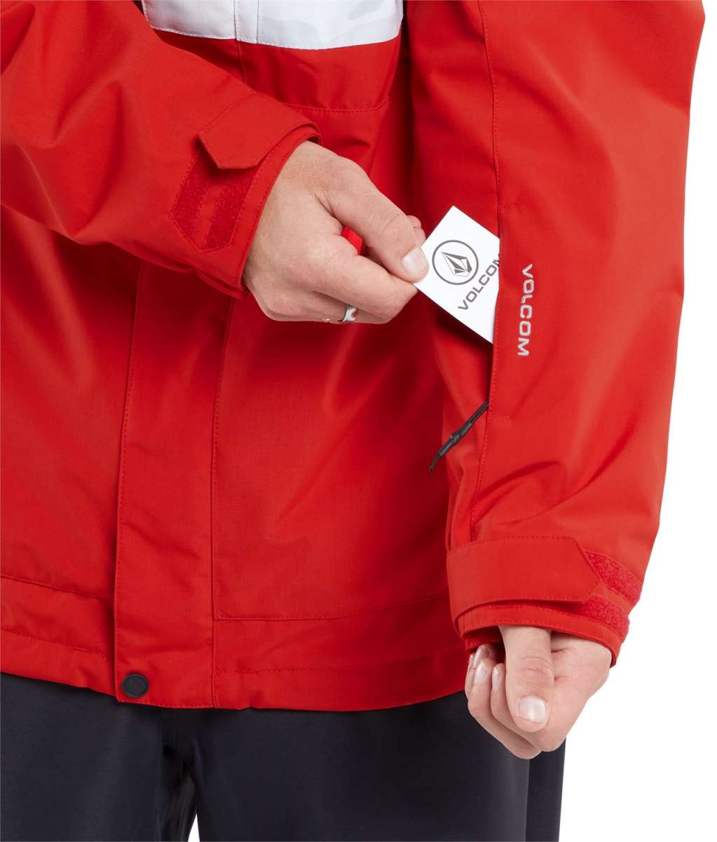 Volcom V.Co Op Shell Jacket 2024 - A red jacket with a white stripe across the chest and black zipper.