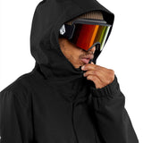 Volcom V.Co Op Shell Jacket 2024 - A black jacket with a hood, featuring a white logo on the left chest and a zippered pocket on the right side.