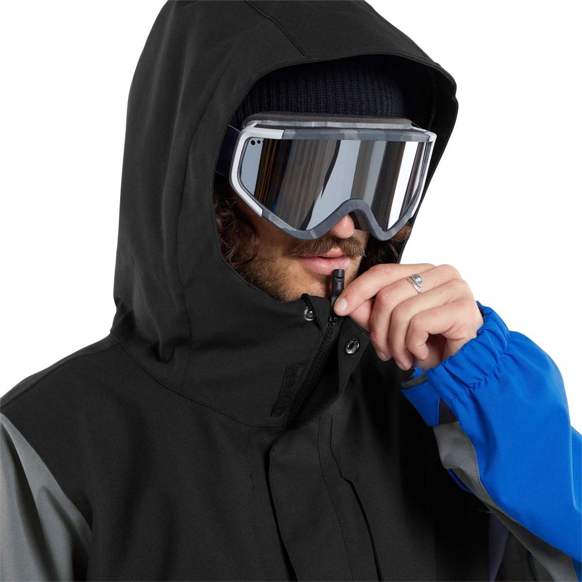 Volcom V.Co Op Shell Jacket 2024 - A black jacket with a high collar and zippered pockets, featuring a reflective logo on the left chest.