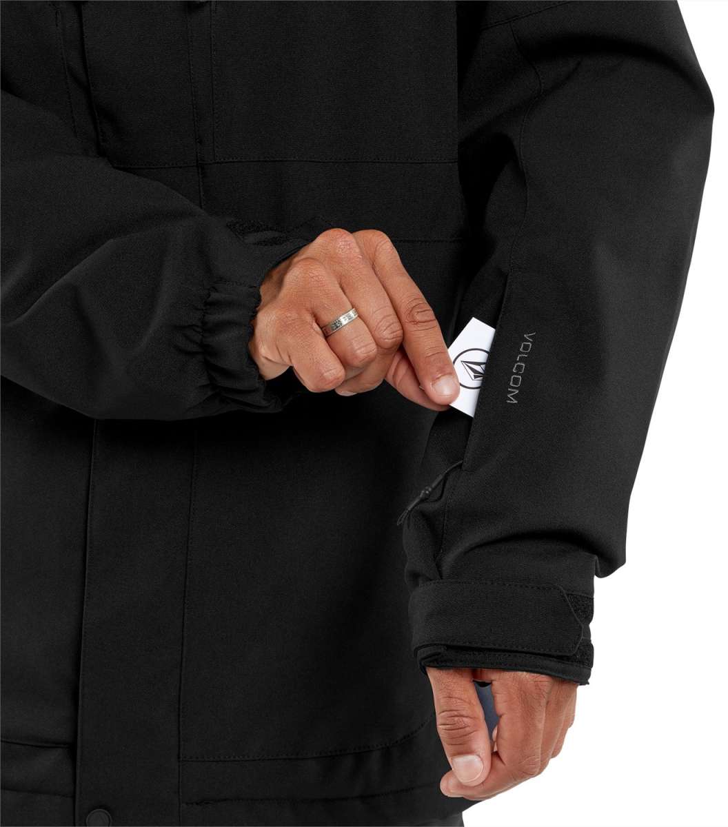 Volcom V.Co Op Shell Jacket 2024 - A black jacket with a white logo on the left sleeve and a white tag near the bottom of the zipper.