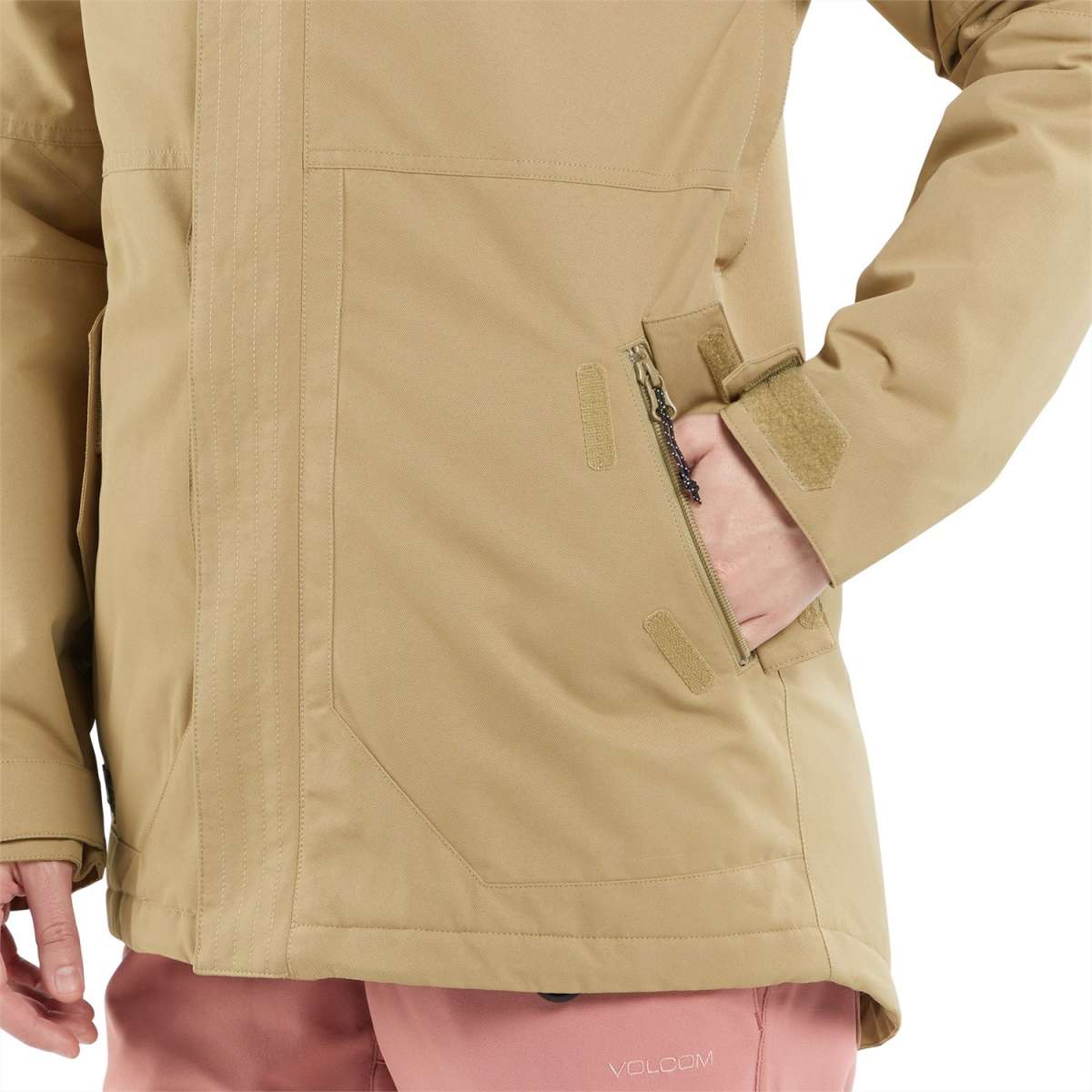 Volcom Women's Fawn Insulated Jacket - A tan-colored jacket with a zippered pocket on the side and a Velcro strap closure at the wrist.