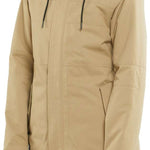 Volcom Women's Fawn Insulated Jacket - A tan-colored jacket with a high collar and zippered pockets, featuring a subtle pattern on the fabric.