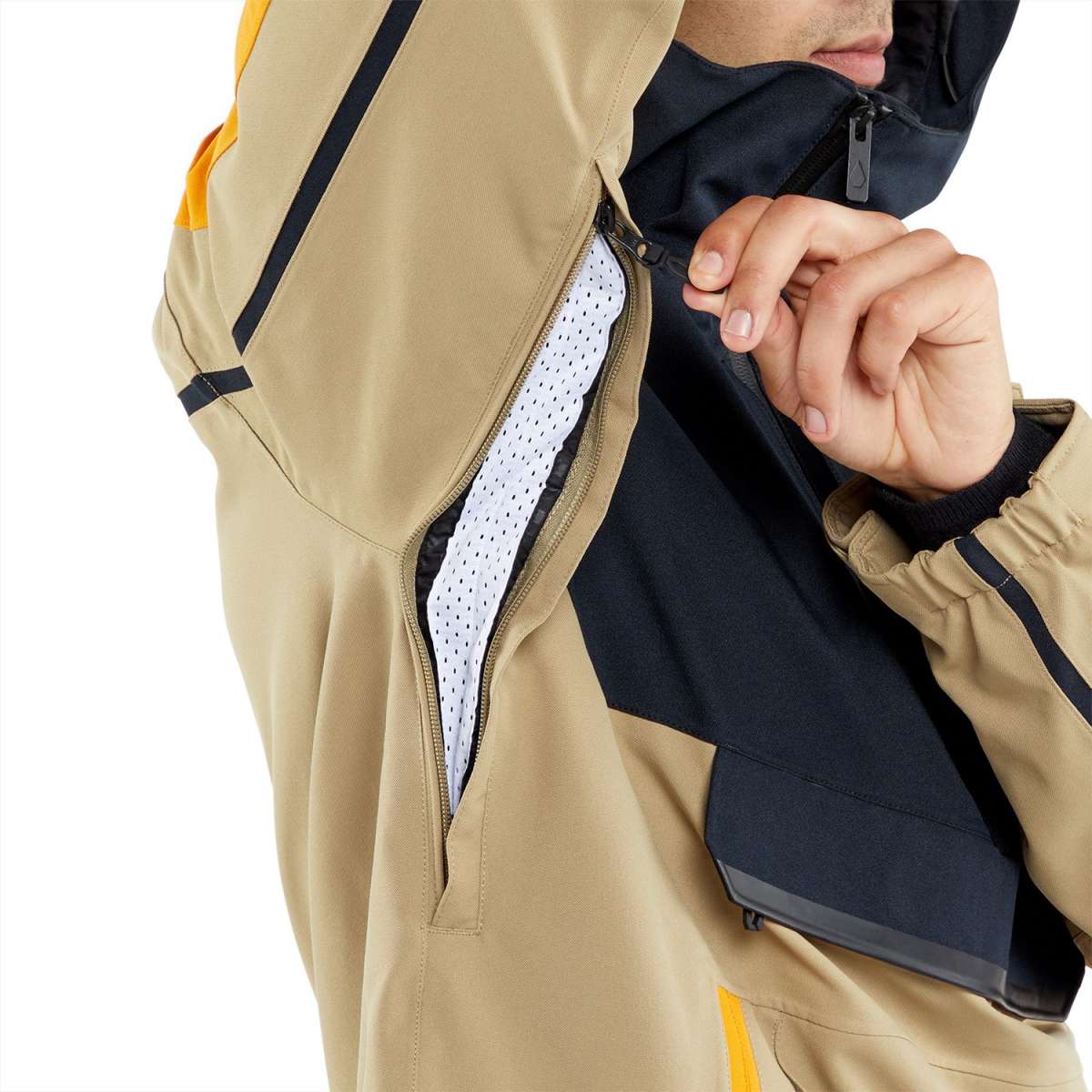 Volcom Brighton Pullover Jacket 2024 - A tan-colored jacket with a black zipper and yellow accents on the shoulder straps.
