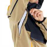 Volcom Brighton Pullover Jacket 2024 - A tan-colored jacket with a black zipper and yellow accents on the shoulder straps.