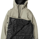 Volcom Brighton Pullover Jacket 2024 - A tan-colored jacket with a hood, featuring a zippered front and two pockets on either side.