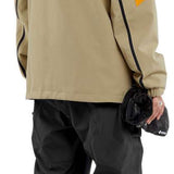 Volcom - A tan jacket with a black hood, featuring orange accents on the shoulders and chest.