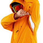 Volcom Dua Insulated GORE-TEX Jacket - A bright orange jacket with a hood, featuring black zippers and adjustable cuffs.