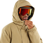 Volcom Dua Insulated GORE-TEX Jacket - A tan jacket with a hood, featuring black zippers and a black logo on the left chest.