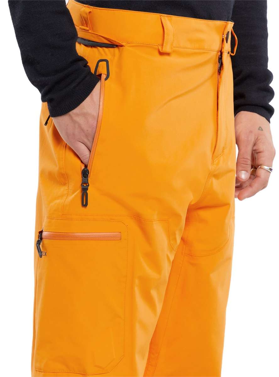 Volcom L GORE-TEX Shell Pant 2024 - A pair of orange snow pants with a zippered pocket on the thigh and an adjustable waistband.