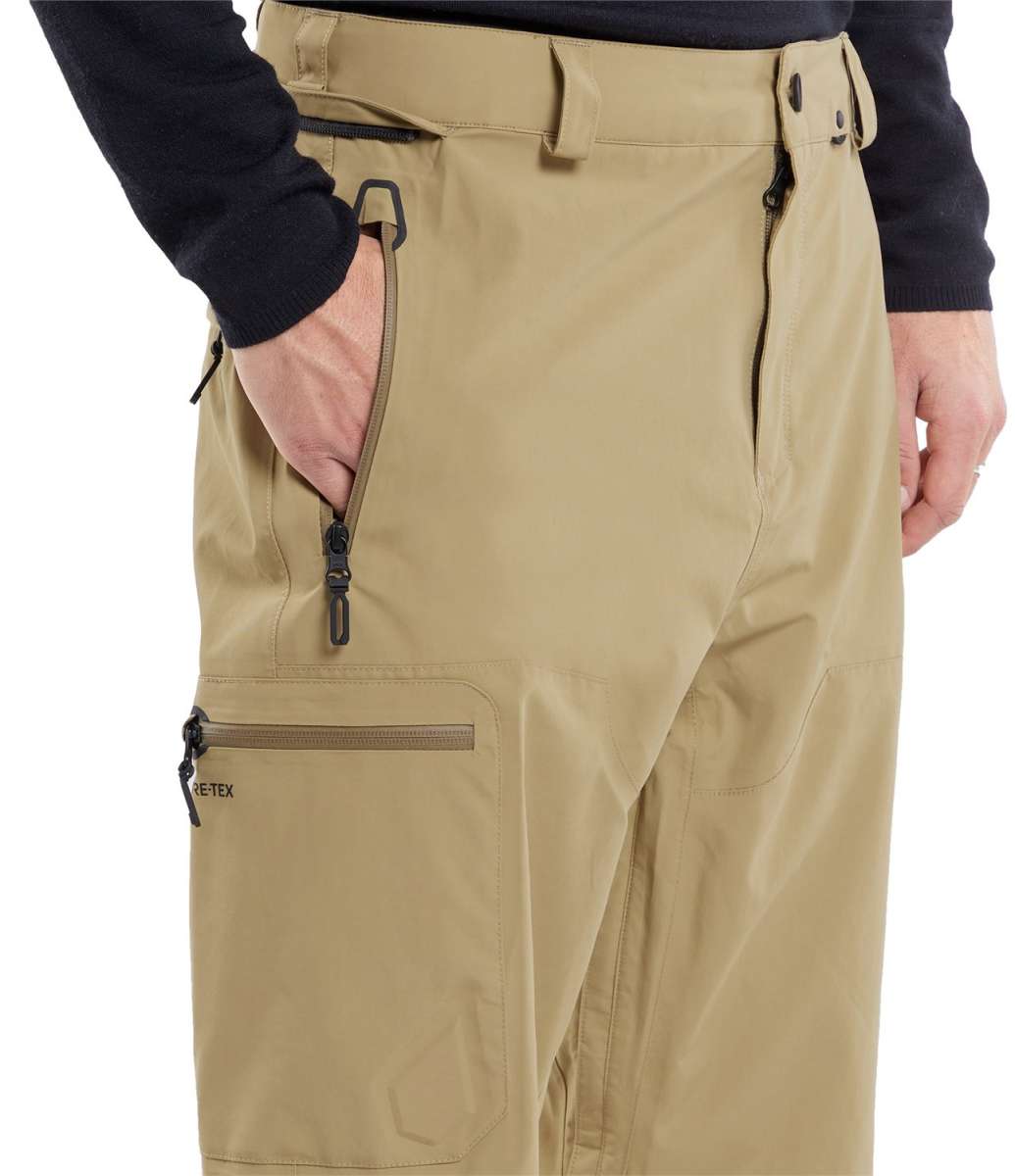 Volcom L GORE-TEX Shell Pant 2024 - A pair of khaki-colored pants with a zippered pocket on the thigh and a black zipper pull.