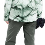 Volcom Women's Bolt Insulated Jacket - A white jacket with a green abstract design and black accents, featuring a hood and zippered pockets.
