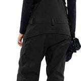 Volcom Women's Creston 3D Stretch Bib Pant - Black bib pant with white logo on left thigh and adjustable Velcro straps at waist.