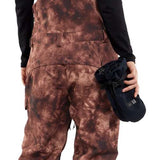 Volcom Women's Creston 3D Stretch Bib Pant - Brown bib pants with a subtle tie-dye pattern and black accents on the side pockets.