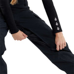 Volcom Women's Creston 3D Stretch Bib Pant - Black bib pant with white logo on left thigh and black zipper fly.