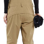 Volcom Women's Elm Stretch GORE-TEX Bib Pant - Black bib with tan stretch fabric and black straps, featuring a zippered fly and two front pockets.