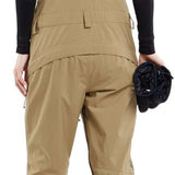 Volcom Women's Elm Stretch GORE-TEX Bib Pant - Black bib with tan stretch fabric and black straps, featuring a zippered fly and two front pockets.