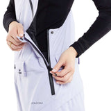 Volcom Women's Elm Stretch GORE-TEX Bib Pant - A pair of white snow pants with a black zipper and snap buttons, featuring a diagonal pattern on the side pocket.