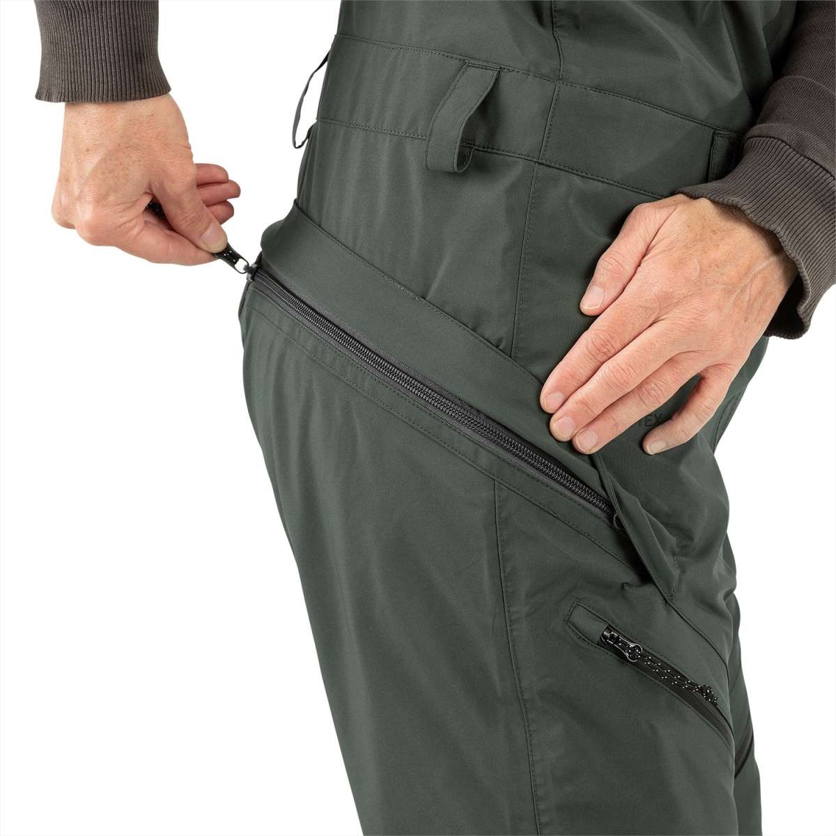 Volcom Women's Elm Stretch GORE-TEX Bib Pant 2024 - Dark green bib pant with diagonal zippered pocket on right thigh and black zipper pull.