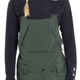 Volcom Women's Elm Stretch GORE-TEX Bib Pant - A pair of dark green bib pants with a geometric pattern on the side, featuring adjustable straps and a zippered fly.
