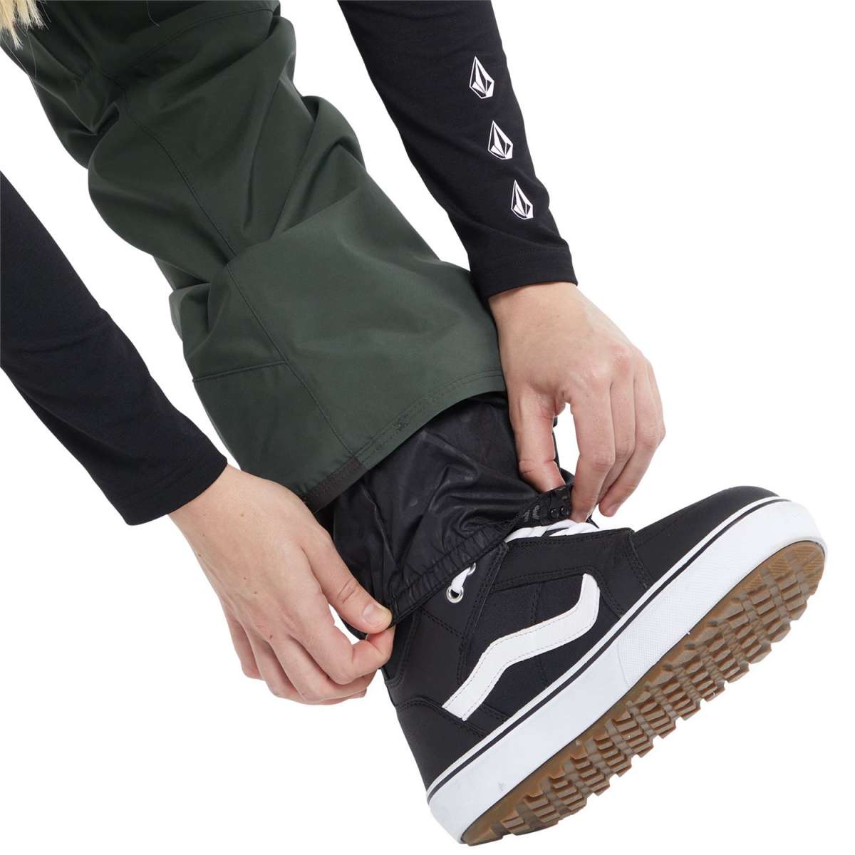 Volcom Women's Elm Stretch GORE-TEX Bib Pant - A pair of dark green snow pants with a white logo on the left thigh and a zippered pocket on the right thigh.