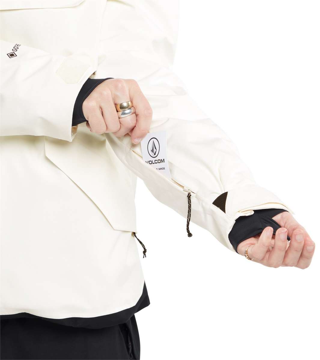 Volcom Women's Fern Insulated GORE-TEX Pullover 2024 - A cream-colored jacket with a black zipper and logo on the left chest, featuring a drawstring at the waist.