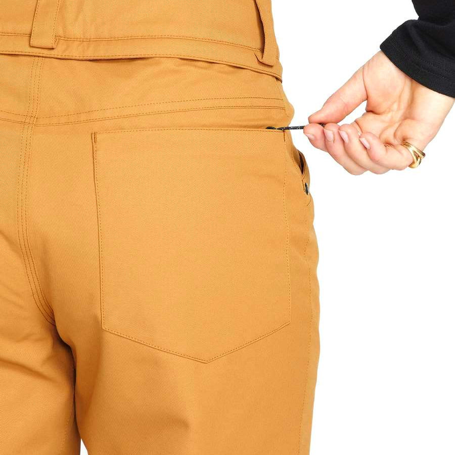 Volcom Women's Hallen Shell Pant 2023 - A pair of khaki-colored snow pants with a zippered pocket on the side.