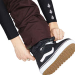 Volcom Women's Knox Insulated GORE-TEX Pant - A pair of brown ski pants with a white logo on the left thigh and a zipper pocket on the right thigh.