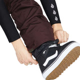 Volcom Women's Knox Insulated GORE-TEX Pant - A pair of brown ski pants with a white logo on the left thigh and a zipper pocket on the right thigh.