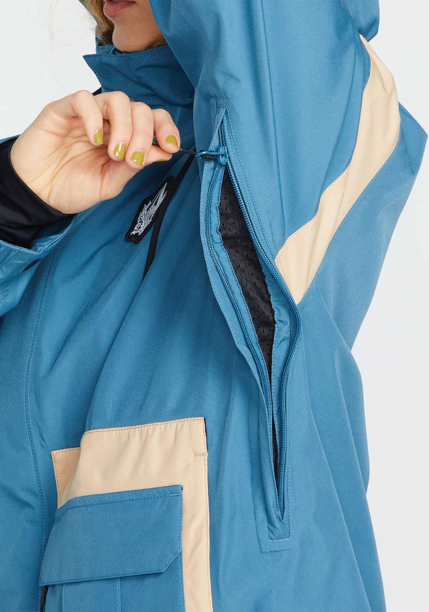 Volcom Women's Melancon GORE-TEX Jacket - A blue jacket with a black zipper and white accents on the chest, worn by a model in front of a gray background.