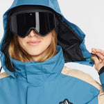 Volcom Women's Melancon GORE-TEX Jacket - A blue and tan jacket with a hood, featuring a black logo patch on the chest.