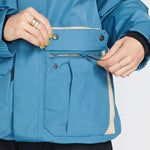 Volcom Women's Melancon GORE-TEX Jacket - A blue jacket with a tan stripe on the side, featuring a zippered chest pocket and two front pockets.