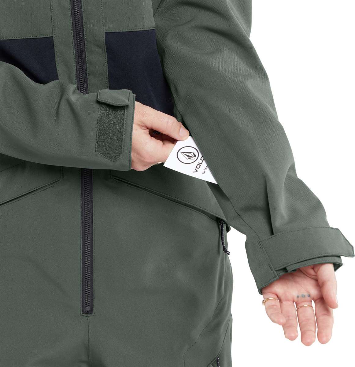 Volcom Women's Shiloh Snow Suit 2024 - A dark green snow suit with a black zipper and two zippered pockets on the front.