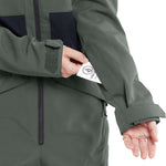 Volcom Women's Shiloh Snow Suit 2024 - A dark green snow suit with a black zipper and two zippered pockets on the front.