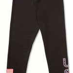 Volcom Women's USA Bottom Base - A pair of black leggings with a white outline of the United States on the left thigh and "USA" in blue letters outlined in red on the right leg.