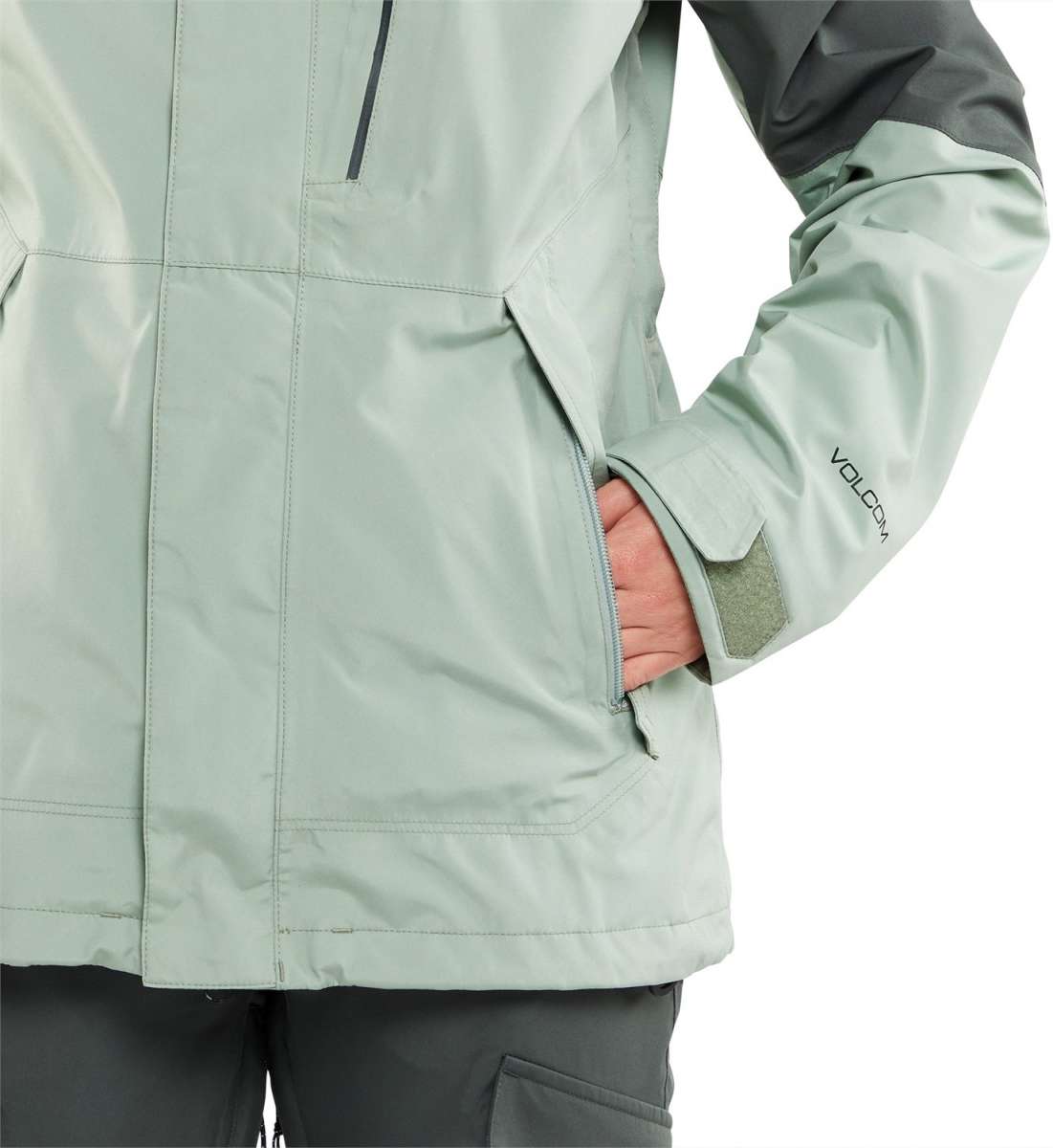 Volcom Women's V.Co Aris Insulated GORE-TEX Jacket 2024 - A light green jacket with a black zipper and two zippered pockets on either side.
