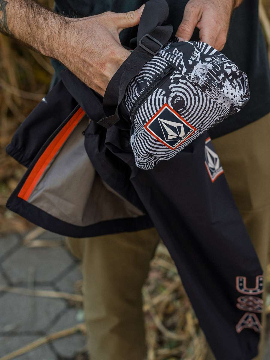 Volcom Pack It USA GORE-TEX Jacket 2022 - A black jacket with a white and red logo on the left chest, featuring a distinctive pattern of concentric circles in white and grey.