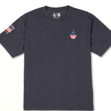 Volcom USA Stone Short Sleeve Tee 2022 - A dark gray t-shirt with a small American flag on the chest and an image of a mountain range in the background.