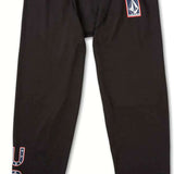 Volcom USST Base Bottom 2022 - Black bottoms with a white logo on the left thigh and red, white, and blue lettering that reads "USST" on the right leg.
