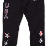 Volcom USST Iconic Stone Pants 2022 - Black pants with a small American flag patch on the left thigh and a white logo on the right leg.