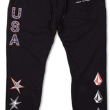 Volcom USST Iconic Stone Pants 2022 - Black pants with a small American flag patch on the left thigh and a white logo on the right leg.