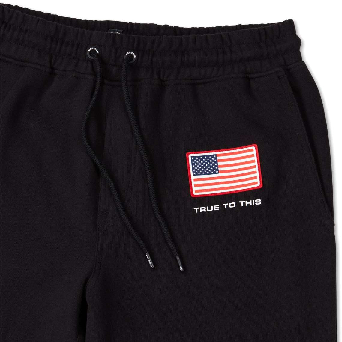 Volcom USST Iconic Stone Pants 2022 - Black pants with a small American flag patch on the left thigh.