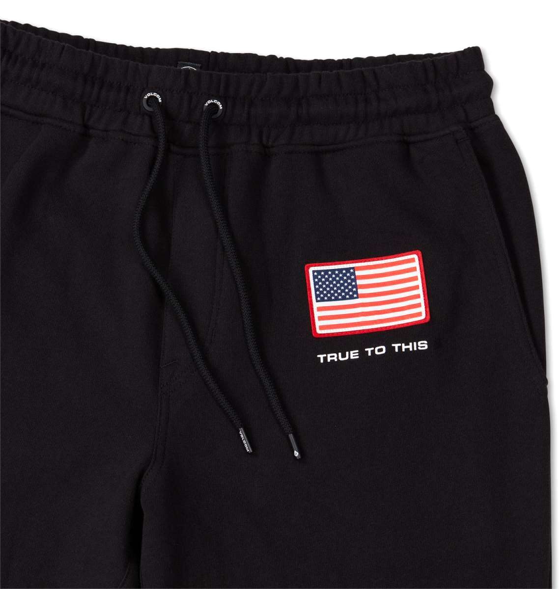 Volcom USST Iconic Stone Pants 2022 - Black pants with a small American flag patch on the left thigh.