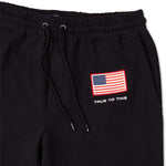 Volcom USST Iconic Stone Pants 2022 - Black pants with a small American flag patch on the left thigh.