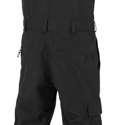 Volcom V.Co Sparta Bib Overall Pants 2024 - Black bib overalls with adjustable straps and multiple pockets, featuring a black-and-white striped pattern on the side of one leg.