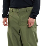 Volcom X Dustbox Pant 2024 - A pair of olive green snow pants with a subtle pattern and zippered pockets.
